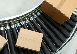 Conveyor belt moving boxes in warehouse